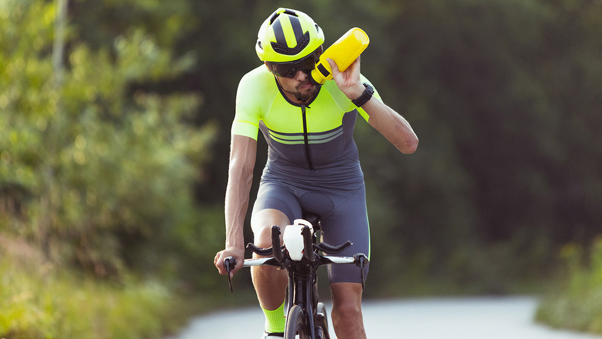 Triathlete On A Bike Drinking Water Getting Nutrition For 70.3 Triathlon