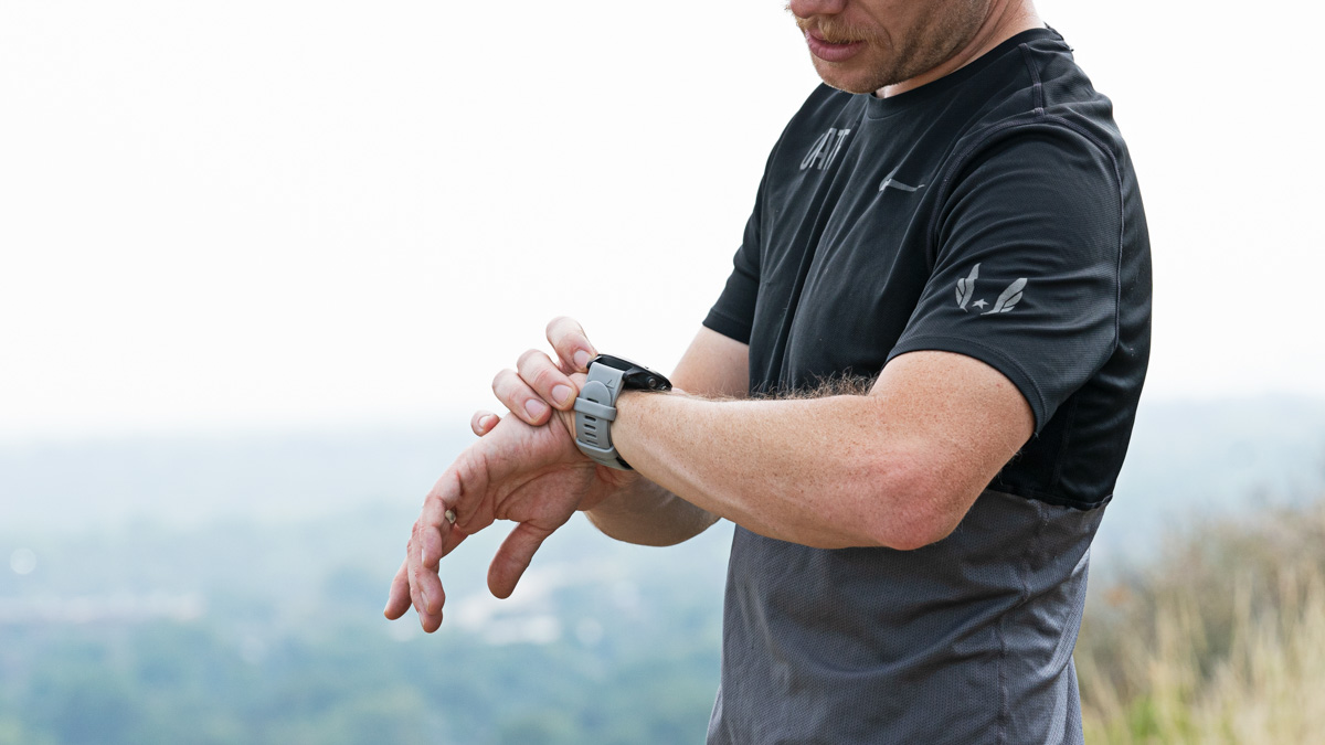 Image Of Trainingpeaks Ambassador Andrew Simmons Assesses Trainingpeaks Metrics For Ultra Runners On His Watch While Doing A Trail Run