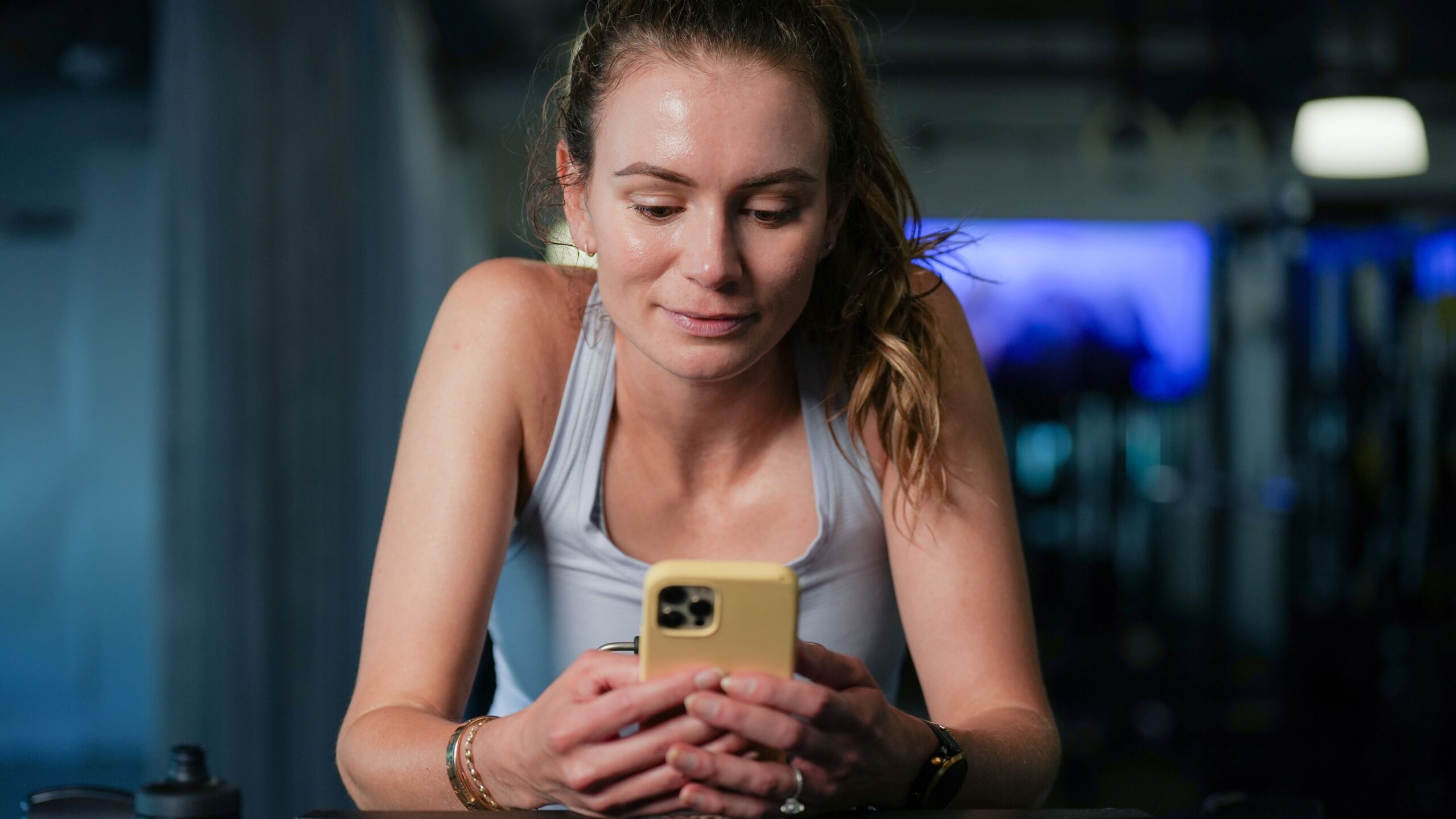 Female Athlete Looking At Trainingpeaks App On Her Phone
