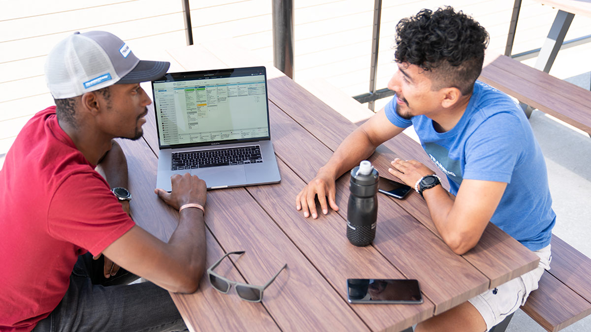 Trainingpeaks Coach And Athlete Sitting Down At A Table Going Over Their Trainingpeaks File