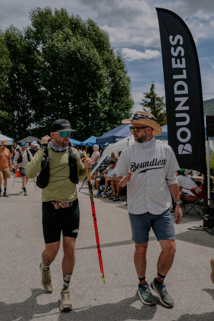 Ultrarunning athlete and Boundless coach at Leadville walking next to each other talking about race strategy