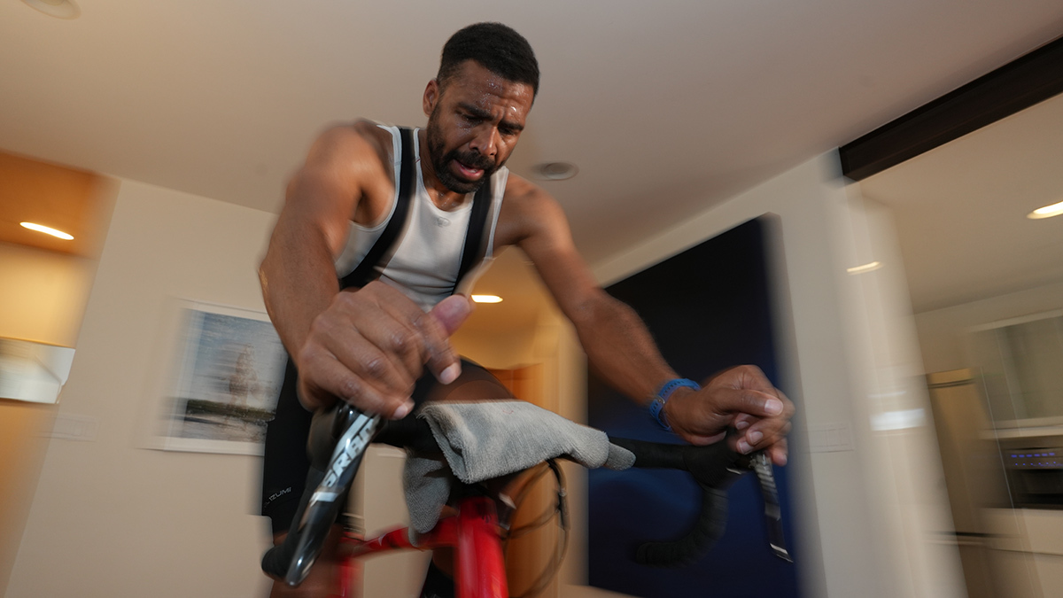 Male Athlete On Indoor Bike Trainer Sweating During An Indoor Workout