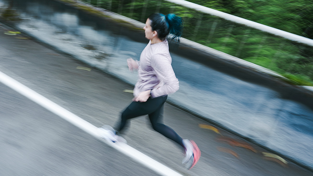 Female Athlete Runner Training For Time On Road