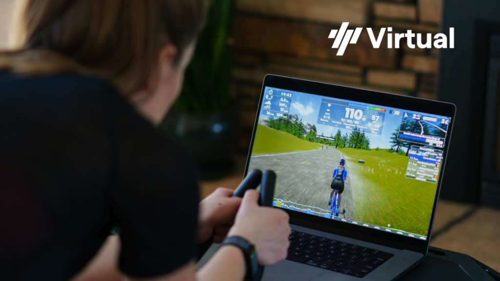 Female Cyclist riding indoor trainer in front of laptop with TrainingPeaks Virtual