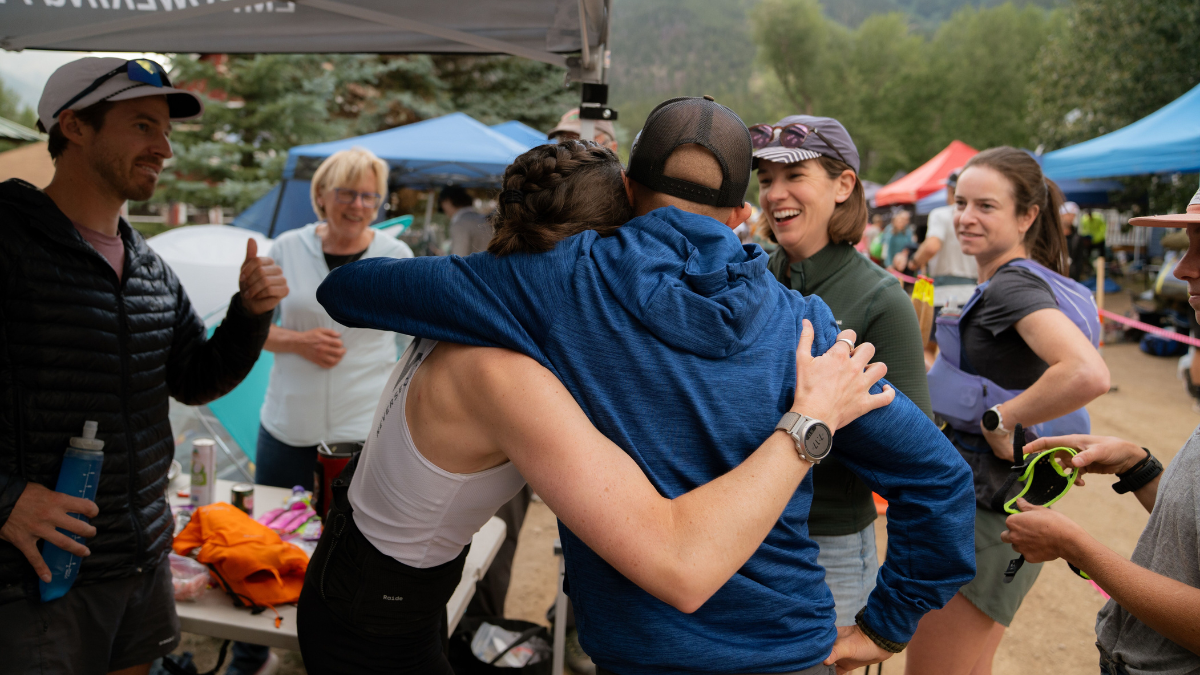 Coach And Athlete Hugging After Endurance Event